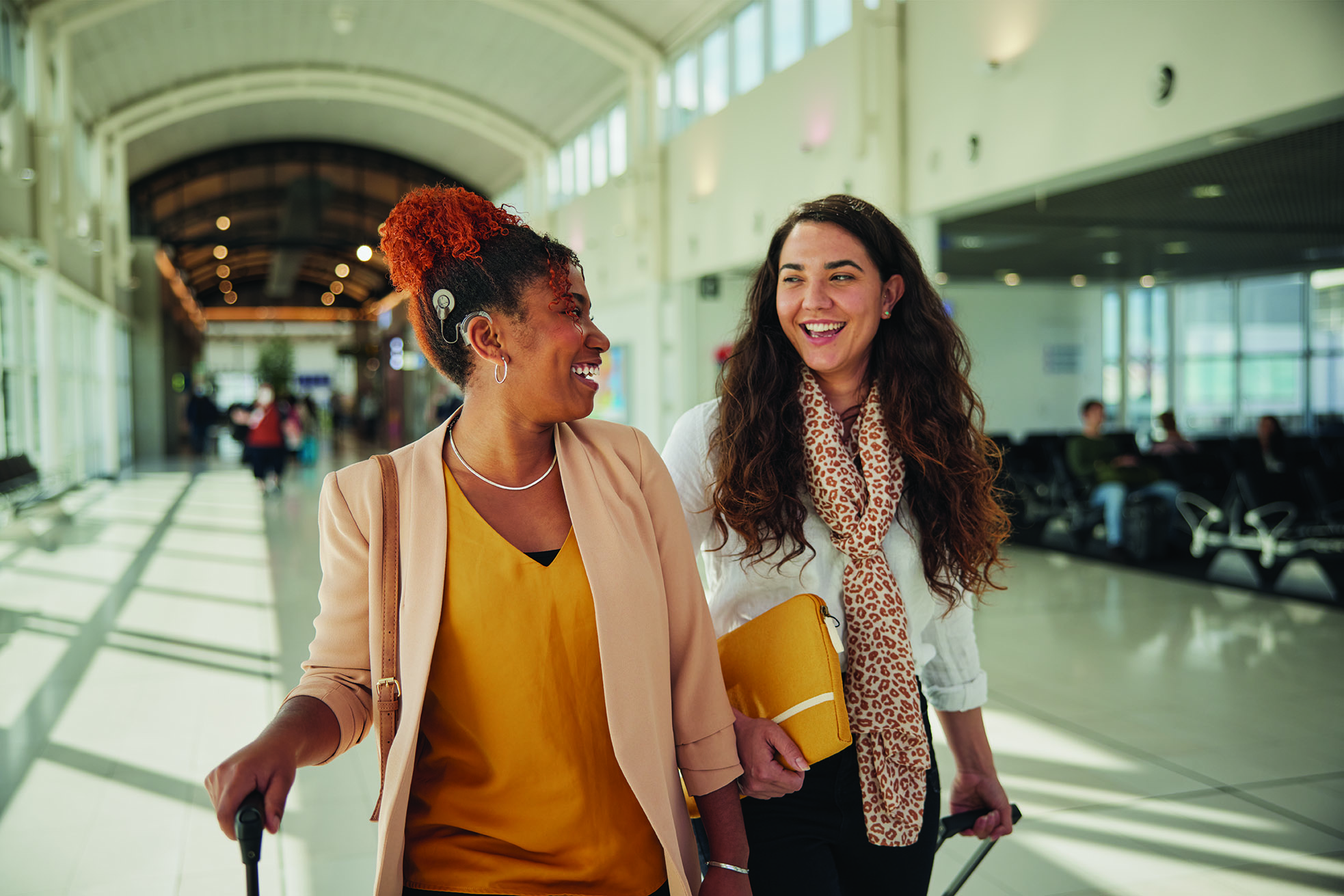 Women at airport with Cochlear Nucleus sound processor.jpg