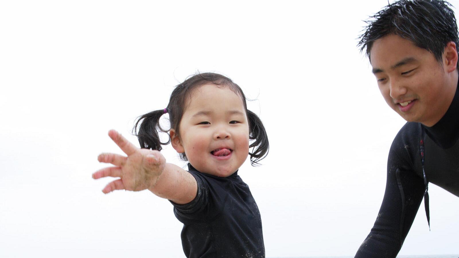 Girl learning to surf with dad.jpg